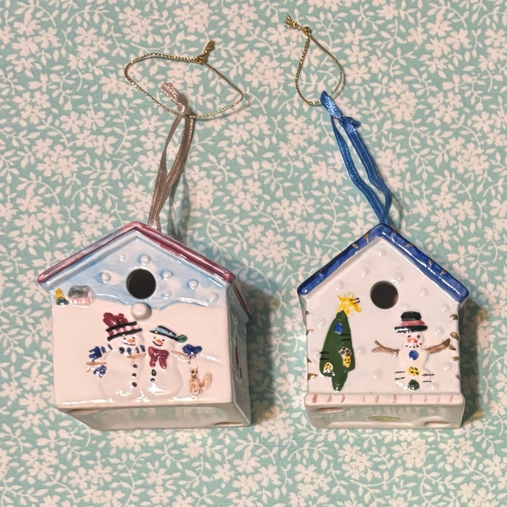 (2) Ceramic Christmas Ornaments featuring snowmen, deer, bird, x-mas trees, etc.